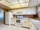 Condo kitchen with white appliances and cabinets at 509 Parkdale Mews # 509, Venice, FL 34285