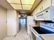 Condo kitchen with white appliances and cabinets at 509 Parkdale Mews # 509, Venice, FL 34285