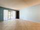 Bright living room with tile floors and sliding glass doors leading to a patio at 509 Parkdale Mews # 509, Venice, FL 34285