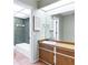 Clean bathroom with wood vanity, tiled shower, and tub at 5221 Lemon Bay Dr, Venice, FL 34293