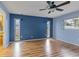 Bedroom with blue accent wall and wood-look floors at 5221 Lemon Bay Dr, Venice, FL 34293