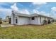 Light gray house exterior with a well-maintained lawn and landscaping at 5221 Lemon Bay Dr, Venice, FL 34293