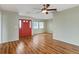 Living room featuring hardwood floors and a red front door at 5221 Lemon Bay Dr, Venice, FL 34293
