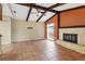 Spacious living room featuring tile floors and a brick fireplace at 5221 Lemon Bay Dr, Venice, FL 34293
