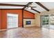 Bright living room with tile floors, fireplace, and exposed wooden beams at 5221 Lemon Bay Dr, Venice, FL 34293