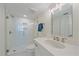 Modern bathroom with glass shower, vanity with large mirror, and bright lighting at 5790 Midnight Pass Rd # 602, Sarasota, FL 34242