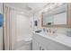 Bathroom features a shower-tub combo, exhaust fan, and vanity sink with cabinets at 5790 Midnight Pass Rd # 602, Sarasota, FL 34242