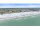 Aerial of sandy beach with surf, beachgoers, and beachfront condos on a sunny day at 5790 Midnight Pass Rd # 602, Sarasota, FL 34242