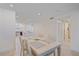 Bright dining room next to kitchen featuring neutral colors, recessed lights, and wood-look tile floors at 5790 Midnight Pass Rd # 602, Sarasota, FL 34242