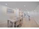Bright dining room next to kitchen featuring neutral colors, recessed lights, and wood-look tile floors at 5790 Midnight Pass Rd # 602, Sarasota, FL 34242