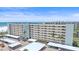 Full exterior view of the condo building from the ground, showcasing balconies, parking, and landscaping at 5790 Midnight Pass Rd # 602, Sarasota, FL 34242