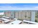 Full exterior view of the condo building from the ground, showcasing balconies, parking, and landscaping at 5790 Midnight Pass Rd # 602, Sarasota, FL 34242