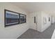Neutral-toned condo hallway with an adjacent window and door at 5790 Midnight Pass Rd # 602, Sarasota, FL 34242