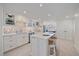 Spacious white kitchen with island seating, modern appliances, and ample counter space, perfect for cooking and entertaining, and a casual snack at 5790 Midnight Pass Rd # 602, Sarasota, FL 34242
