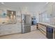 Modern kitchen featuring white cabinets, stainless steel appliances, and custom backsplash at 5790 Midnight Pass Rd # 602, Sarasota, FL 34242