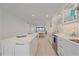 Bright kitchen featuring white cabinetry, tile backsplash, stainless steel appliances, and quartz countertops at 5790 Midnight Pass Rd # 602, Sarasota, FL 34242
