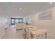 Well-lit living room area with neutral furniture and floor-to-ceiling windows with water view at 5790 Midnight Pass Rd # 602, Sarasota, FL 34242