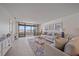 Spacious living room with balcony access, neutral furniture, and stylish decor at 5790 Midnight Pass Rd # 602, Sarasota, FL 34242