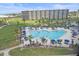 Stunning pool area with lounge chairs and umbrellas, surrounded by lush landscaping at 5790 Midnight Pass Rd # 602, Sarasota, FL 34242