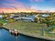 Aerial view of canal-front house with large backyard and private dock at 6462 Fabian Rd, North Port, FL 34287