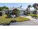 Inviting single-story home showcases a lush lawn, updated roof, and manicured landscaping at 704 Harrington Lake S Dr # 6, Venice, FL 34293