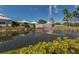 Pond with fountain, landscaping, and clubhouse in background at 704 Harrington Lake S Dr # 6, Venice, FL 34293