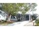Gray mobile home with covered porch and landscaped yard at 727 Blackburn Blvd, North Port, FL 34287