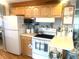 Kitchen with wood cabinets, microwave, and stove at 727 Blackburn Blvd, North Port, FL 34287