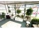 Bright and airy sunroom with ample natural light and abundant potted plants at 727 Blackburn Blvd, North Port, FL 34287