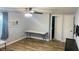 Bright bedroom features tile floors, a ceiling fan, an air conditioner, and access to other rooms in the home at 113 Colonia W Ln, Nokomis, FL 34275