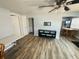 Well-lit living room features wood-like tile, and access to other rooms at 113 Colonia W Ln, Nokomis, FL 34275