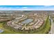 Stunning aerial view of the community showcasing lush landscaping, scenic lakes, and beautiful residential homes at 12837 Oriago St, Venice, FL 34293