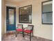 Cozy front porch features stylish seating and an elegant front door, creating an inviting entrance at 12837 Oriago St, Venice, FL 34293