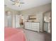 Main bedroom with a decorative ceiling fan, dresser with a mirror, and carpeted flooring at 12837 Oriago St, Venice, FL 34293