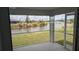Screened lanai overlooking a peaceful pond and lush landscaping at 14464 Fort Myers Ave, Port Charlotte, FL 33981