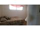 Bright bedroom with a floral quilt and lots of natural light at 300 Base E Ave # 123, Venice, FL 34285