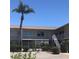 Well-maintained condo building with a beautiful palm tree and accessible staircases at 300 Base E Ave # 123, Venice, FL 34285