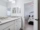 Bathroom with a granite vanity and a mirror, as well as an open door at 5930 Anise Dr, Sarasota, FL 34238