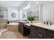 Bathroom with double vanity, shower, soaking tub, and natural light at 5930 Anise Dr, Sarasota, FL 34238