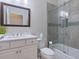 This bathroom features a sink with shower-tub combo with sliding glass doors at 5930 Anise Dr, Sarasota, FL 34238