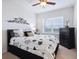 This spacious bedroom features a ceiling fan and a window with a view at 5930 Anise Dr, Sarasota, FL 34238