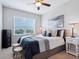 This bedroom is illuminated by natural light with a ceiling fan and furnishings at 5930 Anise Dr, Sarasota, FL 34238