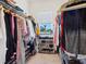 Walk-in closet with a large window and shelving for shoes and clothes at 5930 Anise Dr, Sarasota, FL 34238