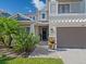 Home's entryway with tropical foliage and a cozy, welcoming ambiance at 5930 Anise Dr, Sarasota, FL 34238