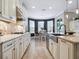 Bright kitchen with stainless steel appliances, granite countertops, and a dining nook at 5930 Anise Dr, Sarasota, FL 34238
