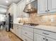 Kitchen with stainless steel appliances, granite countertops, tiled backsplash, and custom cabinetry at 5930 Anise Dr, Sarasota, FL 34238