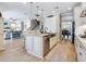 Kitchen island featuring a farm sink and a view of the living area and staircase at 5930 Anise Dr, Sarasota, FL 34238