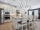 Well-lit kitchen with stainless steel appliances, a central island, and modern pendant lighting at 5930 Anise Dr, Sarasota, FL 34238