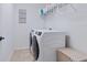 Bright laundry room with a modern washer and dryer, plus a handy shelf for storage at 5930 Anise Dr, Sarasota, FL 34238