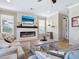 Cozy living room featuring a fireplace, TV, and comfortable seating at 5930 Anise Dr, Sarasota, FL 34238